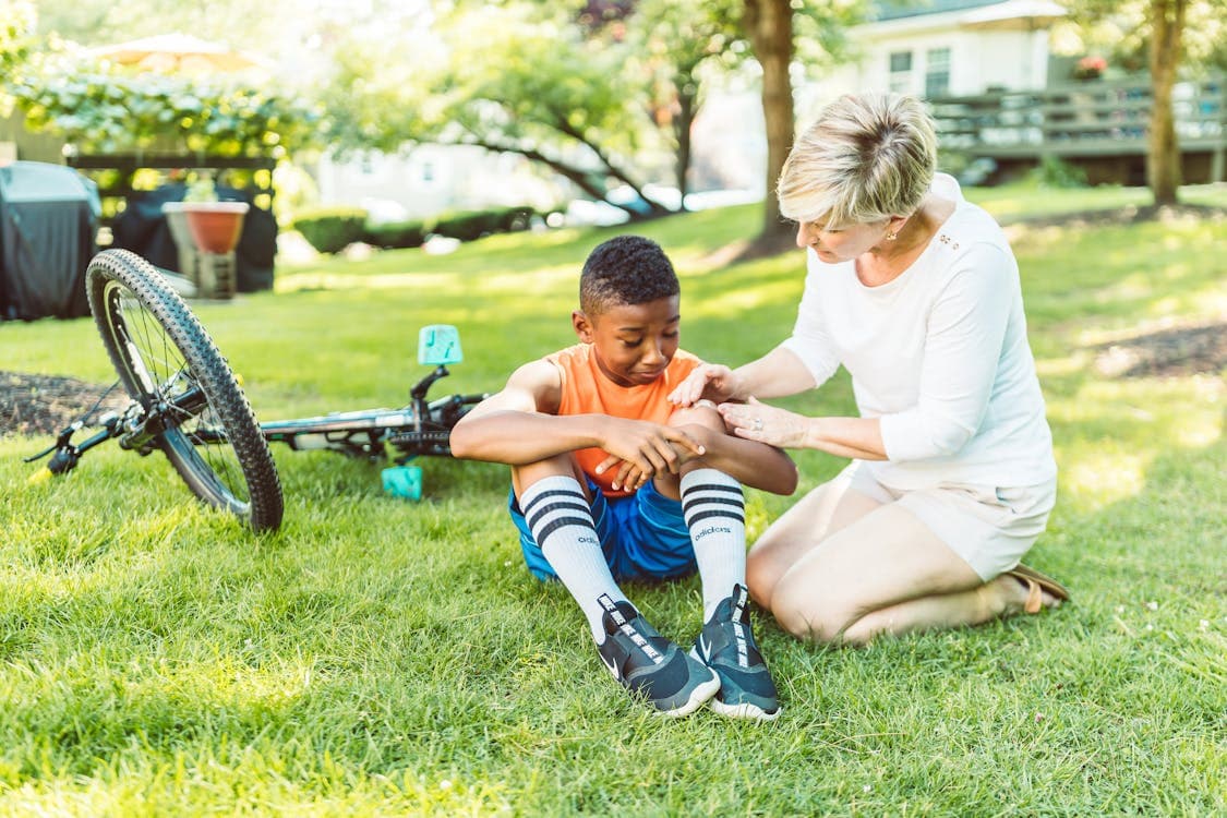 Cyclist examining an injury after a bicycle accident