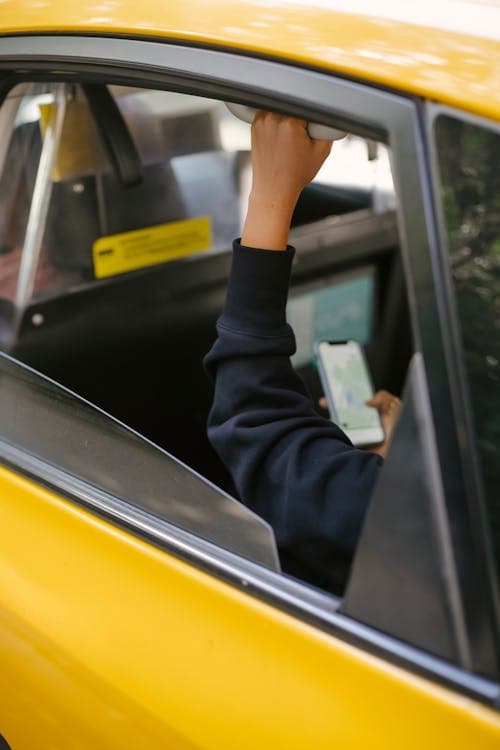 Passenger in a rideshare vehicle using a smartphone